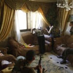 A Free Syrian Army fighter fires his sniper rifle from a house in Aleppo