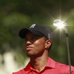 The sun reflects off the club as Tiger Woods hits off on the seventh tee at the AT&T National golf tournament in Bethesda, Maryland