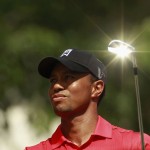 The sun reflects off the club as Tiger Woods hits off on the seventh tee at the AT&T National golf tournament in Bethesda, Maryland