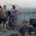 Local residents meet during sunset, with the Metallurgical Plant seen in the background, in the Southern Urals city of Magnitogorsk