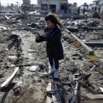 Kumaga visits the spot where her house, which was washed away by the March 11, 2011 tsunami, used to stand in Higashimatsushima