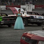 Dressed as a princess, Knoepfel stands in the pits waiting for the next race during the Saturday night stock car races at Agassiz Speedway in Agassiz