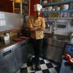 Manolis Ouranos, a 30 year-old cook, poses for a picture in the Mavros Gatos tavern in Psiri neighboorhood in central Athens