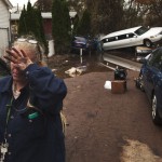 A woman weeps after learning that a neighbor presumed missing is okay while cleaning out her home in a neighborhood heavily damaged by Hurricane Sandy in the New Dorp Beach neighborhood