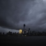 The skyline of lower Manhattan is in darkness except for Goldman Sachs building after a preventive power outage caused by giant storm Sandy as seen from Exchange Place,  in New York