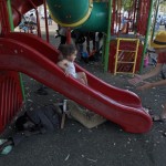 Sudanese migrant sleeps under a slide in South Tel Aviv