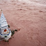 A temple stands amid the waters of the flooded river Tawi after heavy rains in Jammu