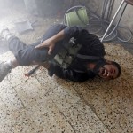 A Free Syrian Army fighter screams in pain after he was injured in a leg by shrapnel from a shell fired from a Syrian Army tank in the Salaheddine neighbourhood of central Aleppo