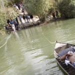 A wounded Syrian man lies on a boat as he is transferred to Turkey over the Orontes river on the Turkish-Syrian border near the village of Hacipasa in Hatay province