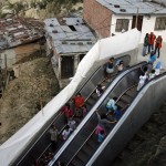 People travel on an outdoor public escalator at Commune 13 in Medellin