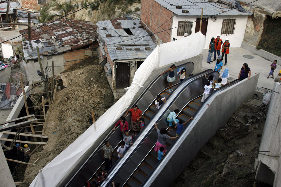 People travel on an outdoor public escalator at Commune 13 in Medellin