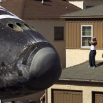 A man takes a photo as Space Shuttle Endeavour travels to the California Science Center in Inglewood, Los Angeles