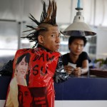 A young man dressed as a punk with pictures of Myanmar pro-democracy leader Aung San Suu Kyi on his shirt, attends a punk show during the water festival at a music bar in Yangon