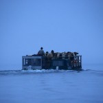 Bavarian farmers transport their cows on a boat over the picturesque Lake Koenigssee at dusk