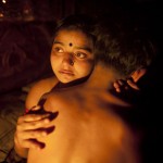Seventeen-year-old prostitute Hashi, embraces a Babu, her "husband", inside her small room at Kandapara brothel in Tangail, a northeastern city of Bangladesh