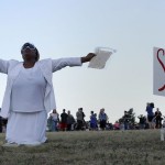 Perkins prays during a vigil for victims behind the theater where a gunman opened fire in Aurora, Colorado