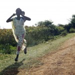 A woman runs along a road during an air strike by the Sudanese air force in Rubkona near Bentiu