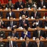 Delegates sit at stage before opening ceremony of 18th National Congress of Communist Party of China at Great Hall of People in Beijing