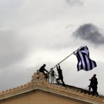 Parliament employees raise flag atop the parliament in Athens