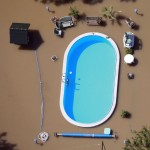 Garden with swimming pool is inundated by waters of Elbe river during floods near Magdeburg