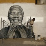 Tavares works on a graffiti of Nelson Mandela which he painted during festivities in his neighborhood in Lisbon