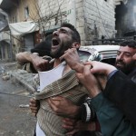 A father reacts after the death of two of his children, whom activists said were killed by shelling by forces loyal to Syria's President Bashar al-Assad, at al-Ansari area in Aleppo