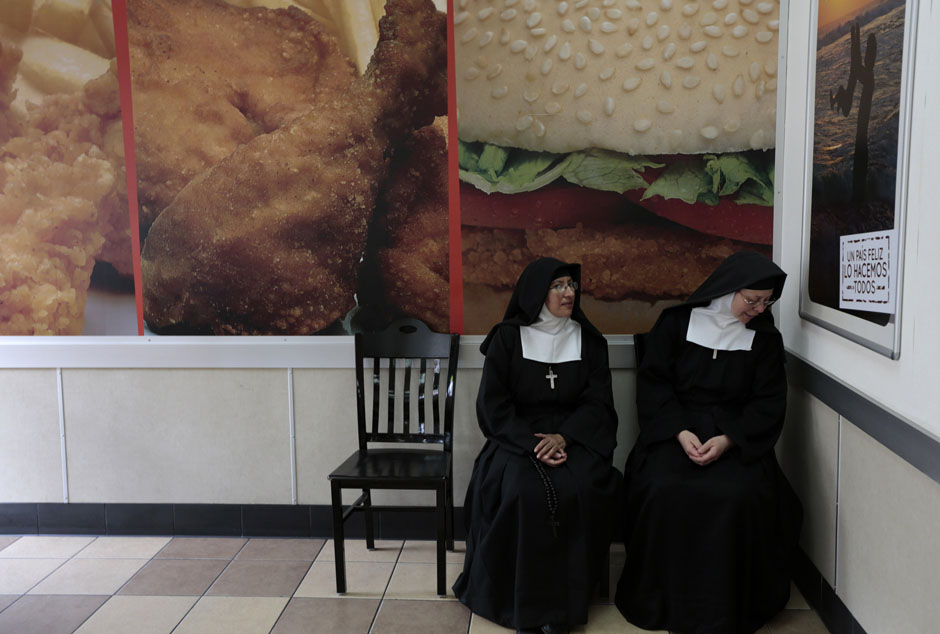 Nuns sit at a fast food restaurant downtown of Guatemala City