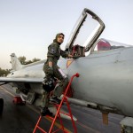 Ayesha Farooq, 26, Pakistan's only female war-ready fighter pilot, climbs up to a Chinese-made F-7PG fighter jet at Mushaf base in Sargodha