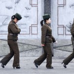 Female North Korean soldiers patrol along the banks of Yalu River, near the North Korean town of Sinuiju