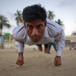 Ram Pratap Verma, a 32-year-old aspiring Bollywood film actor, practices gymnastics on a beach in Mumbai