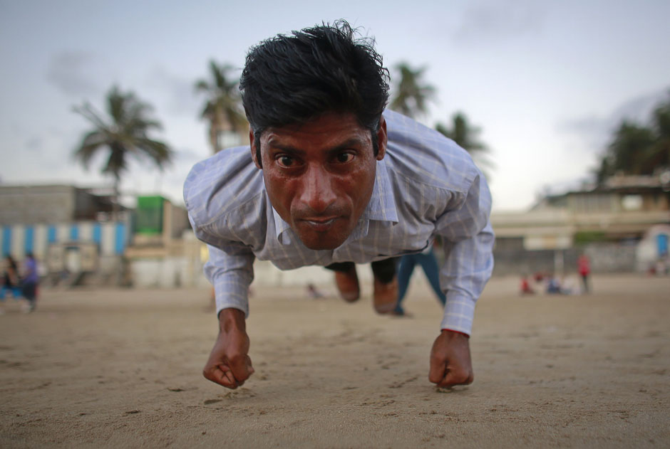 Ram Pratap Verma, a 32-year-old aspiring Bollywood film actor, practices gymnastics on a beach in Mumbai