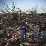 Danielle Stephan holds boyfriend Thomas Layton as they pause between salvaging through the remains of a family member's home one day after a tornado devastated the town Moore, Oklahoma