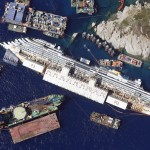 An aerial view shows the Costa Concordia as it lies on its side next to Giglio Island taken from an Italian navy helicopter