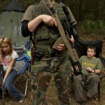 Member of the North Florida Survival Group wait with their rifles before heading out to perform enemy contact drills in Old Town
