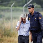 An injured man, identified by Spanish newspapers El Pais and El Mundo as the train driver Garzon, is helped by a policeman after a train crashed near Santiago de Compostela