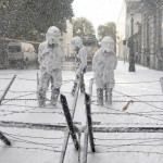 Belgian riot police are covered with foam sprayed by Belgian firefighters during a protest for better work conditions in central Brussels