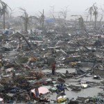 Survivors stand among debris and ruins of houses destroyed after Super Typhoon Haiyan battered Tacloban city in central Philippines