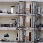 A man checks an apartment on a damaged building at the site of a blast in Reyhanli