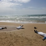 Bodies of migrants who drowned lie on the beach in the Sicilian village of Sampieri