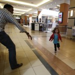 A child runs to safety as armed police hunt gunmen who went on a shooting spree at Westgate shopping centre in Nairobi
