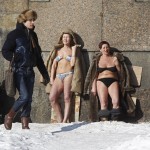 People sunbathe by the wall of the Peter and Paul Fortress in St. Petersburg