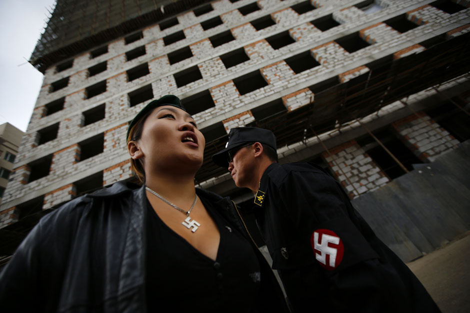 Ariunbold and Uranjargal, leaders of self-described neo-Nazi group Tsagaan Khass, stand next to a construction site in Ulan Bator