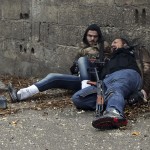 A Free Syrian Army fighter looks at his comrade as he gets shot by sniper fire during heavy fighting in the Ain Tarma neighbourhood of Damascus
