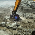 An excavator moves villagers away from a flooded area during heavy rainfall in Yingxiu