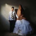 Palestinian groom Ahmed Soboh and his bride Tala stand inside Tala's house which damaged during Israeli strike in 2009, during wedding party in Beit Lahiya