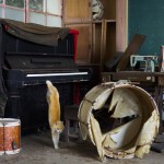 A cat jumps off a piano in the music room of a derelict school on Aoshima Island in the Ehime prefecture in southern Japan
