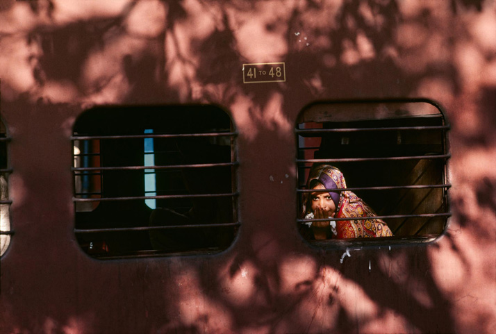 00246_01 An Indian girl peers out of a train window, 1983.