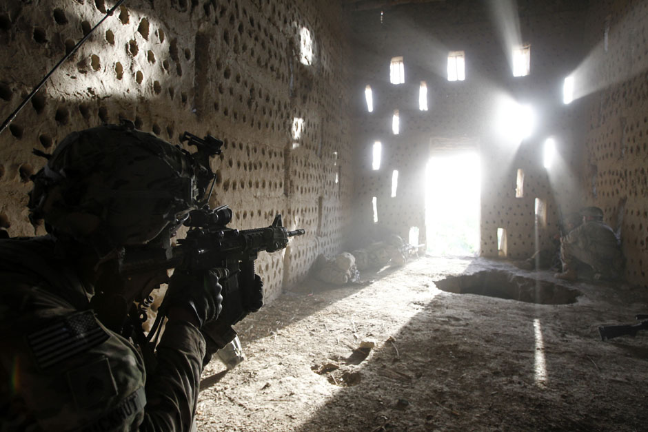 U.S. soldier points his rifle after coming under fire in Zharay district in Kandahar province, southern Afghanistan