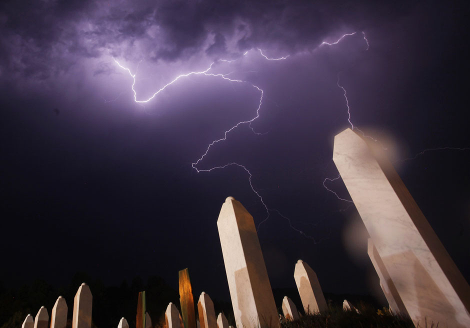 Lightning is seen during a storm under the Memorial Center in Potocari the night before a mass burial