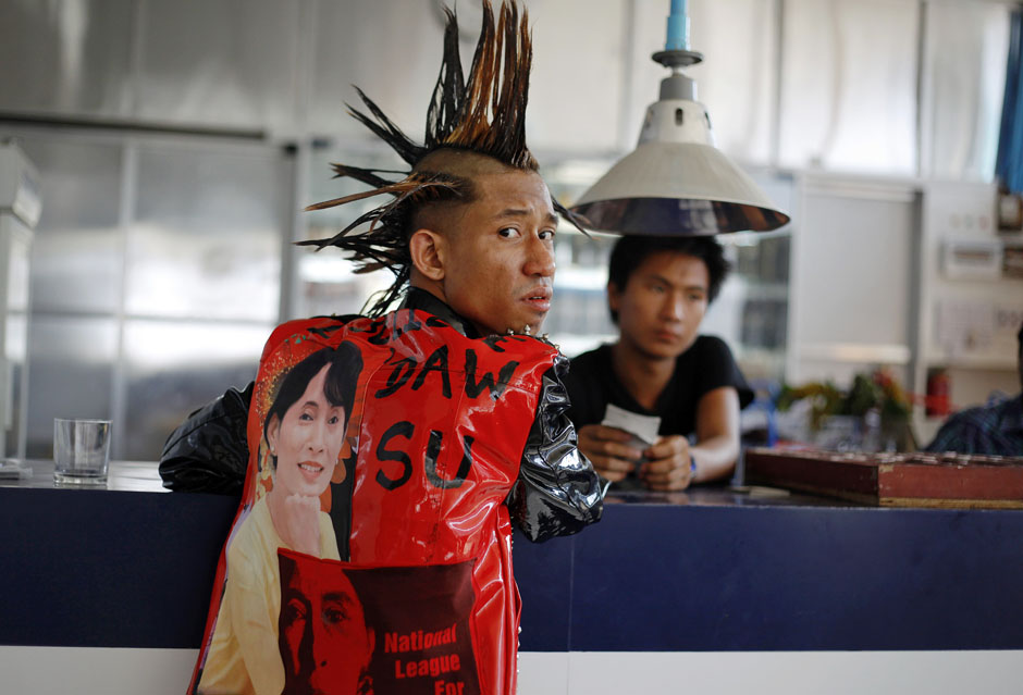 A young man dressed as a punk with pictures of Myanmar pro-democracy leader Aung San Suu Kyi on his shirt, attends a punk show during the water festival at a music bar in Yangon